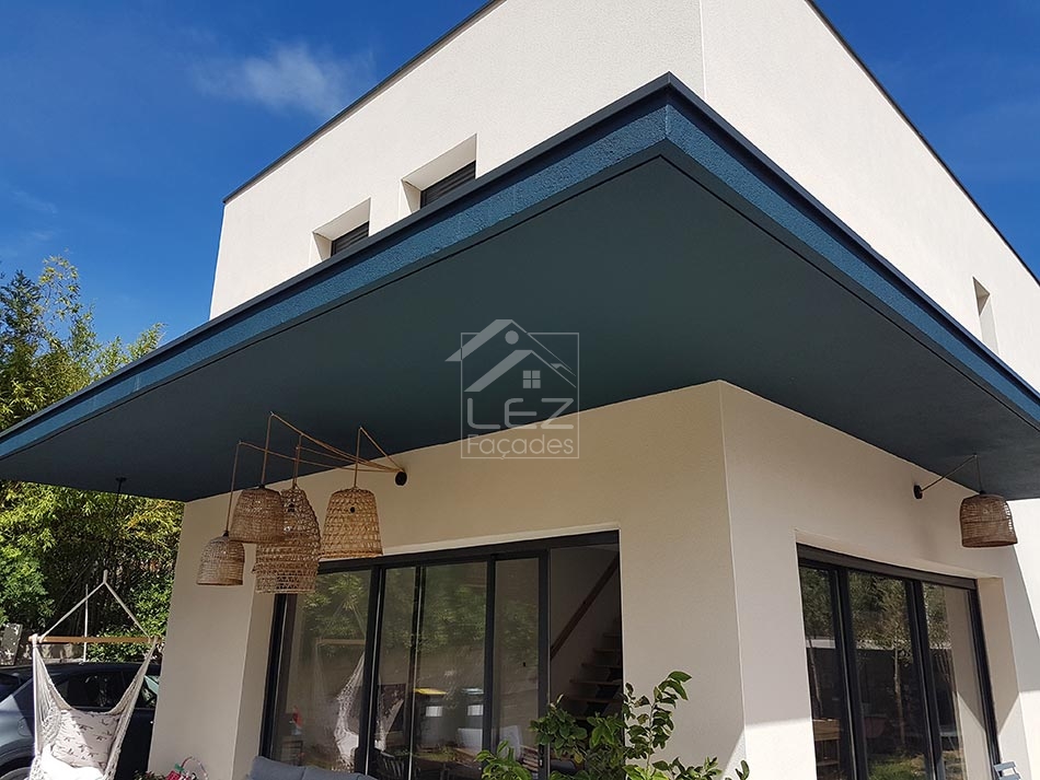 Maison moderne avec auvent bleu et luminaires suspendus